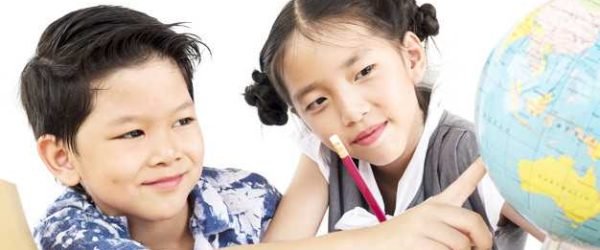 Asian kids are studying the globe over white background